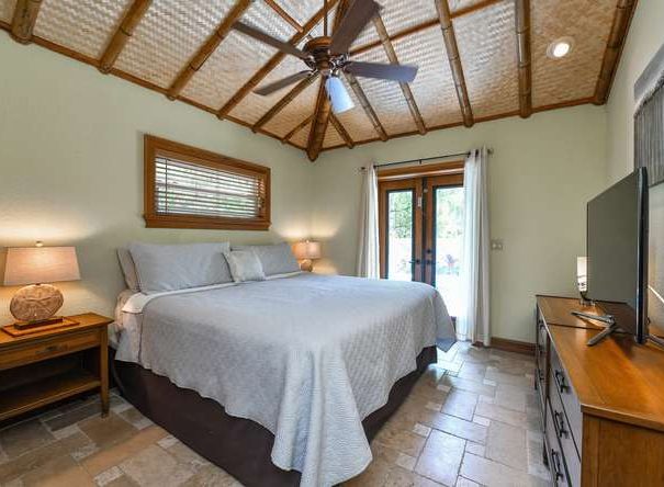 Master bedroom with a King size mattress and bamboo sheets with a view of the pool!